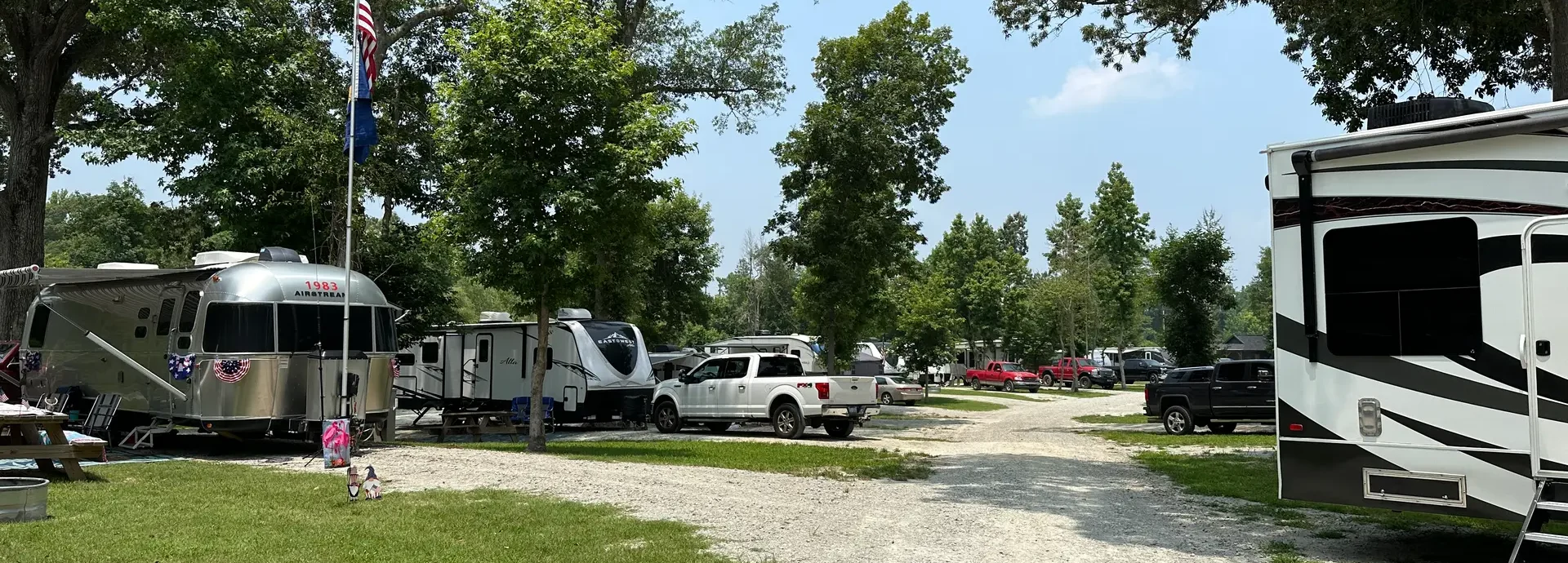 RV sites under the trees at Magnolia Lane Campground in summer