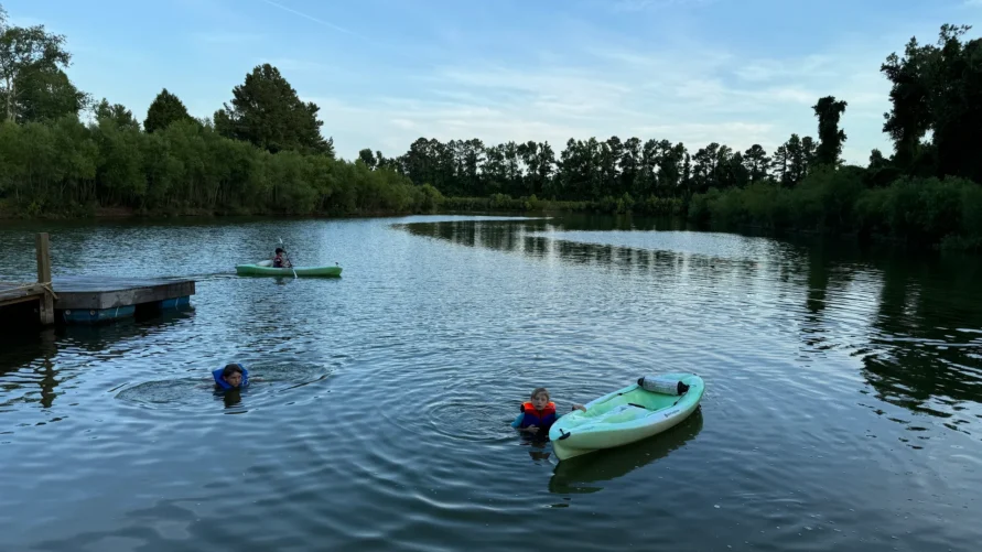 Kids swimming and kayaking on Lake Georgia